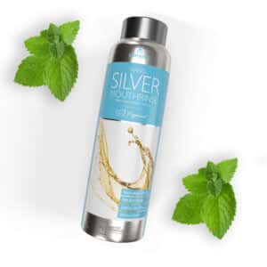 Elementa Silver mouth rinse in peppermint flavor with peppermint leaves in the background