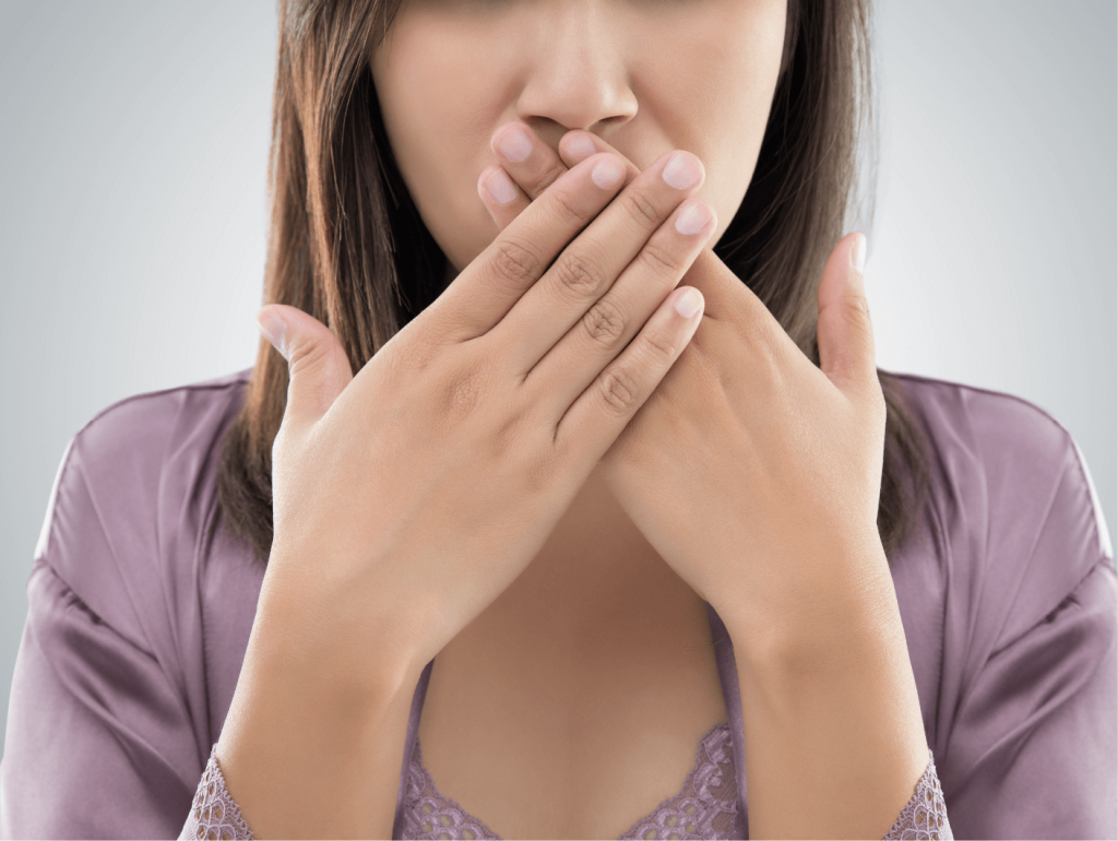 photo of woman covering her mouth with both hands because she is embarrassed or surprised