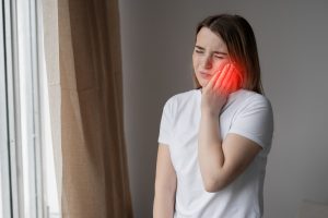 woman with toothache wondering how to get rid of cavities